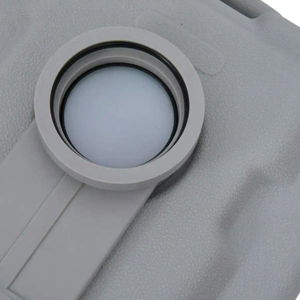 Grey toilet lid close-up showing round flush opening and inner seal ring