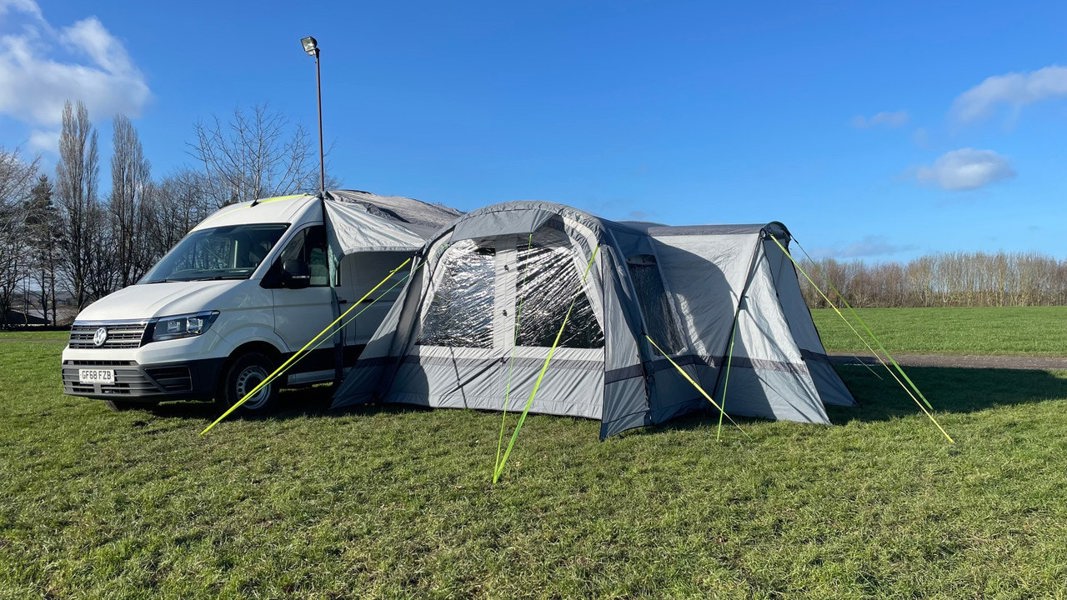 The Cocoon Breeze® XL v2 Motorhome Awning (Grey) from OLPRO pictured in a campsite attached to a VW Crafter Camper Van