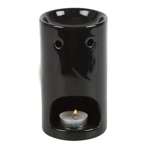 Black skeleton hand oil burner with inner tray and small flame, circular top