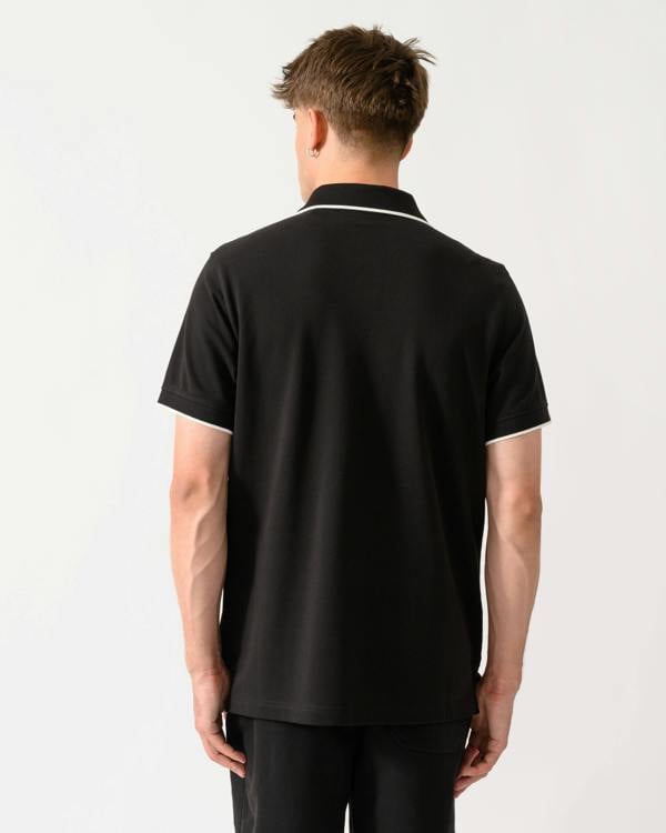 back shot of a model wearing a Belstaff Mens Tipped Polo Shirt in Black