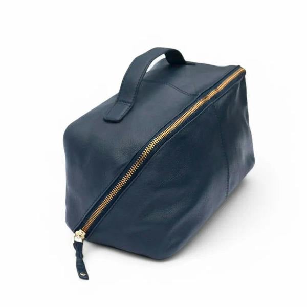 Large Leather Makeup Washbag in navy , showcasing its soft leather exterior, structured rectangular shape, and sturdy top handle.