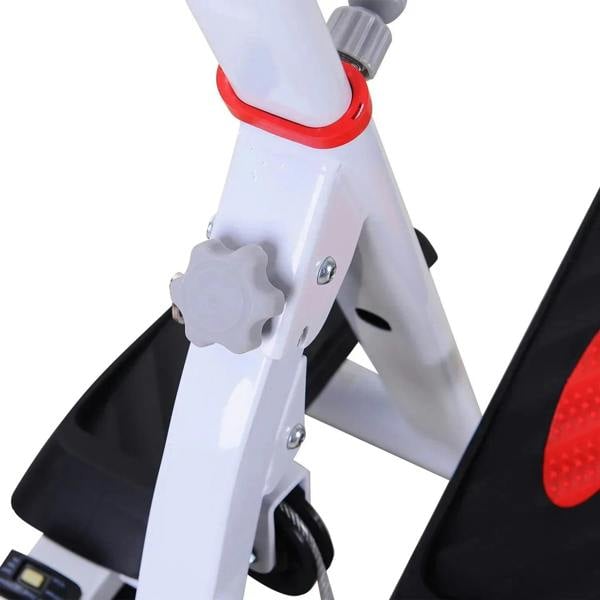 White stepper frame close-up with red pivot knob and black pedal support