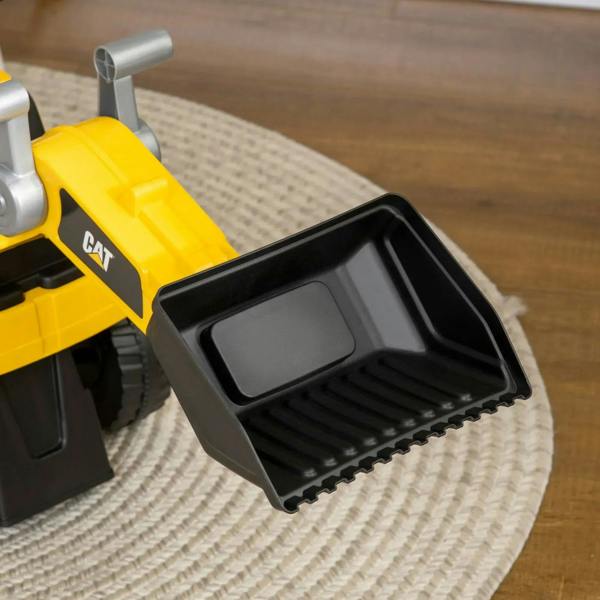 Close-up of yellow CAT ride-on excavator black front bucket with textured surface