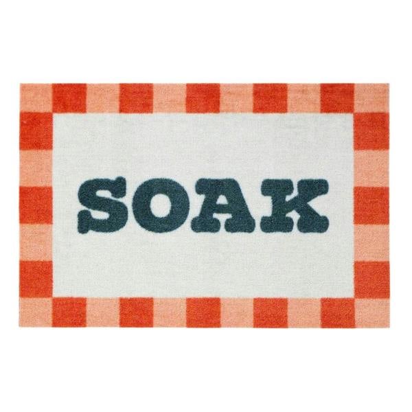 Doormat with red and white checkered border and 'SOAK' text in the center