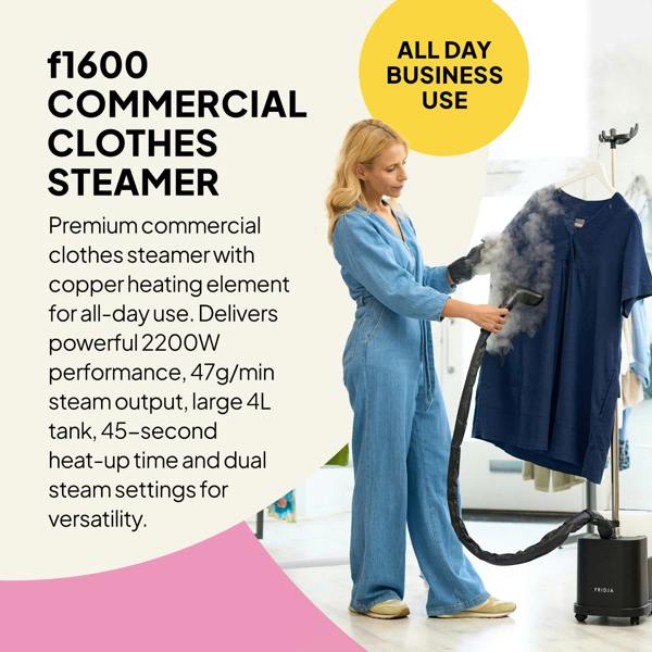 A woman in a blue jumpsuit uses the black Fridja f1600 Steamer from the Commercial Garment Care Trio on a hanging navy shirt. Text highlights its high power, large tank, and all-day business suitability. Includes f10 Handheld & f40 Fabric Shaver.