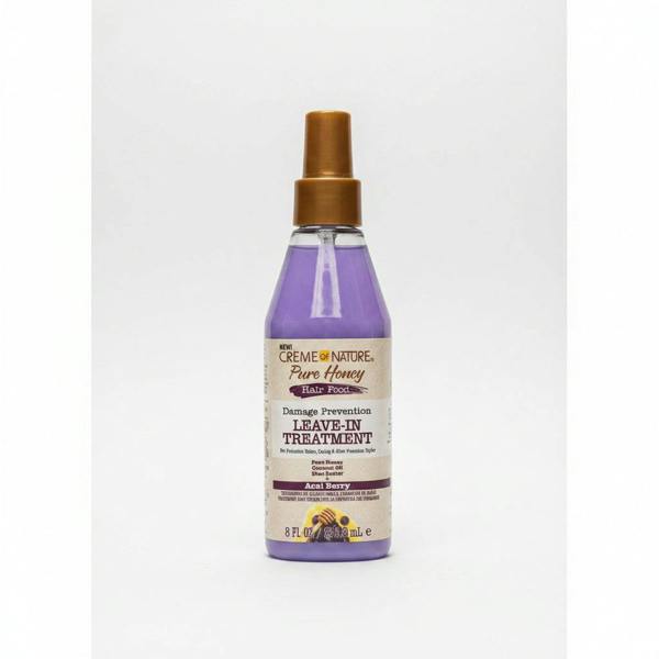 Bottle of Creme of Nature Pure Honey Damage Prevention Leave-In Treatment on a white background
