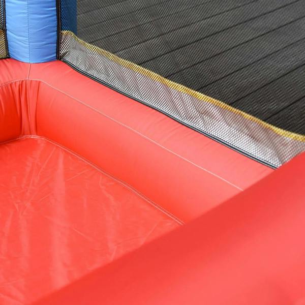 Inflatable bounce castle play surface with red padded edges and black mesh wall