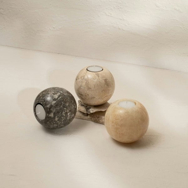 Set of three spherical marble candle holders for home décor