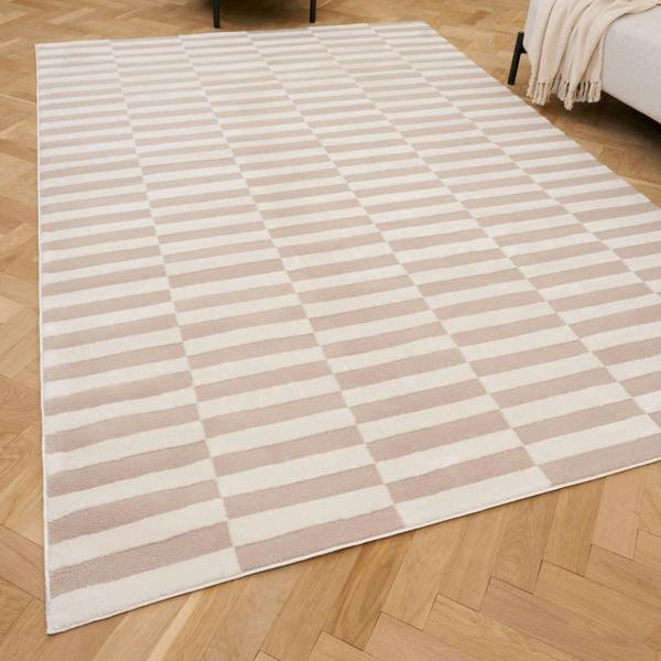 Beige and white checkered rug on a wooden floor