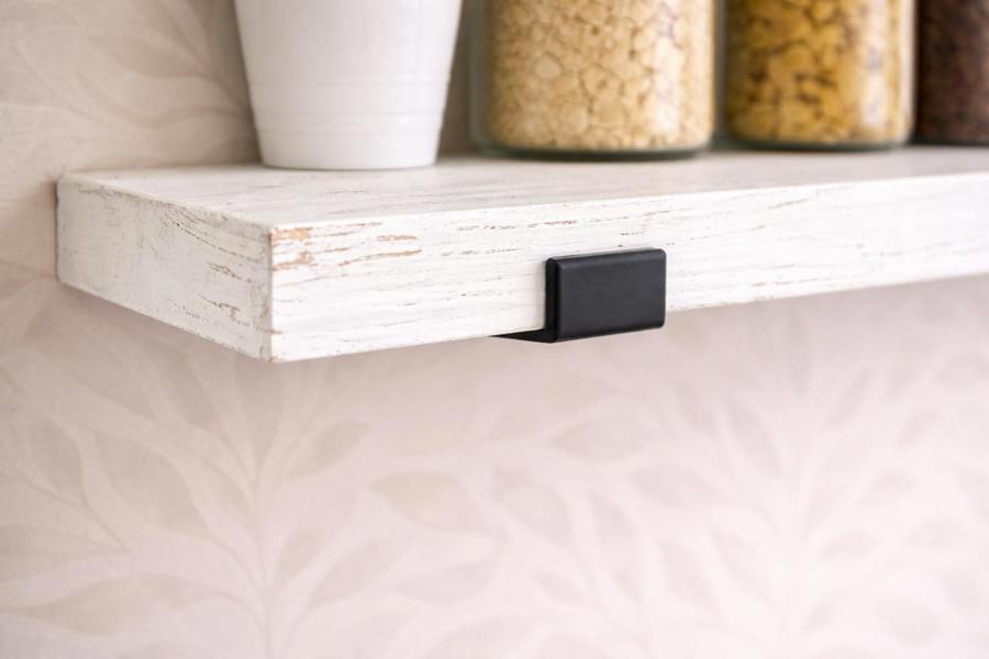Close up of distressed white reclaimed scaffold board shelf showing texture