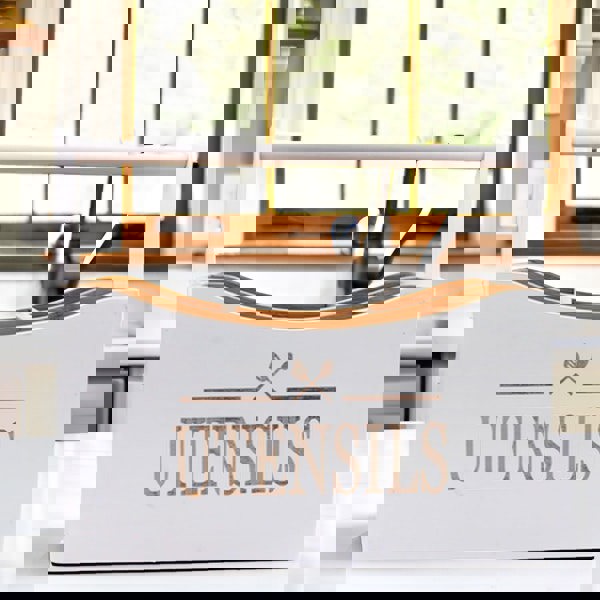 White utensil holder with 'UTENSILS' text in a kitchen setting