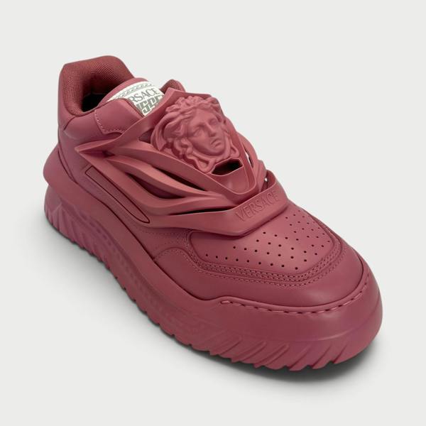 Supplied Fashion Versace Odissea sneakers in jam red featuring a prominent Medusa head motif and chunky rubber sole.