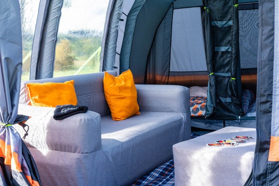 The inside of the Blakedown Breeze 4 Berth Inflatable Tent from OLPRO showing an inflatable sofa and the bedroom pod.