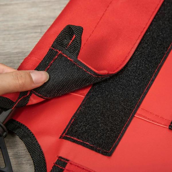 Red elevated dog bed edge with black fastening straps and padded mesh