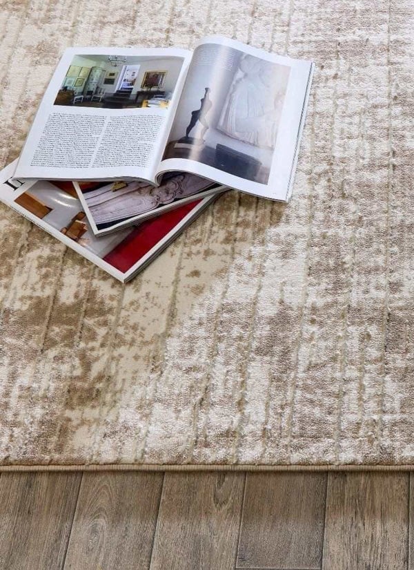 Abstract geometric rug in neutral tones with magazines on soft textured surface.