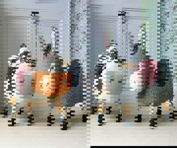 Moobert Cow Ride On Toy standing with Bojangles Donkey Ride On Toy