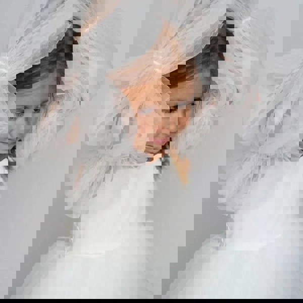 Girl holding her arms above her head 