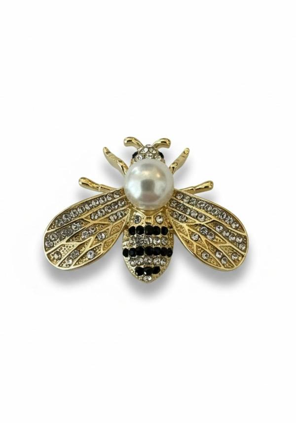 Jeweled bee brooch with pearl body on a white background