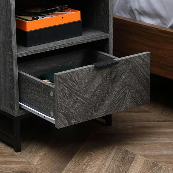 Dark grey bedside table drawer open with internal shelf, steel legs.
