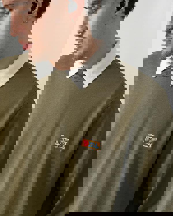 close up shot of a model wearing Fjallraven Vardag Mens Sweater in Green 620