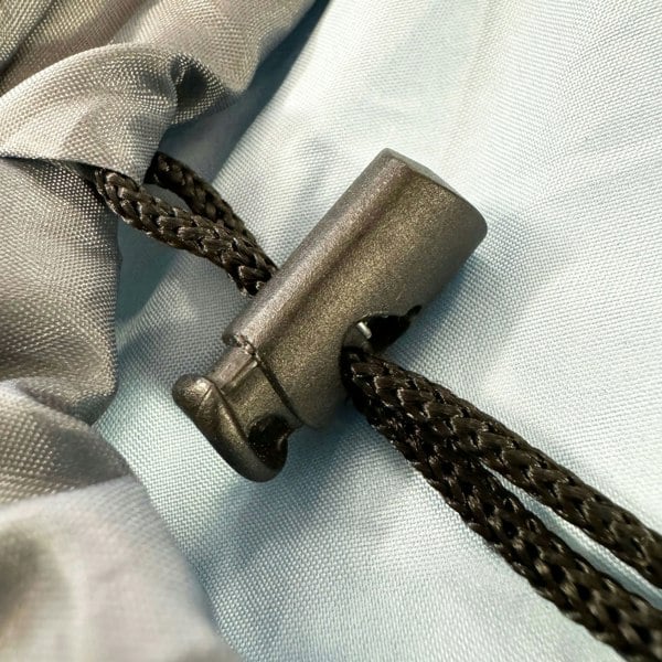 A closeup image of the drawstring toggle of the OLPRO X Stafford Sleeping Bag