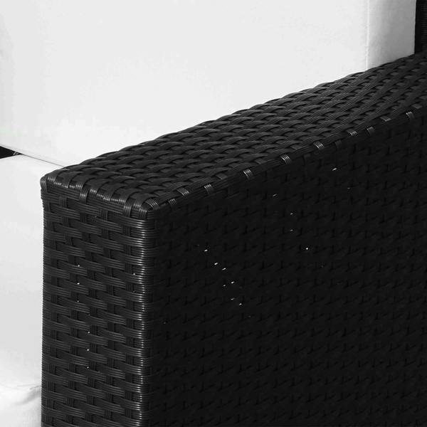 Black woven rattan armchair corner detail with thick white seat cushion