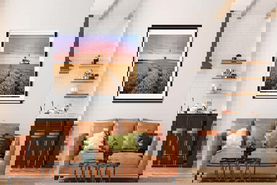 framed wall print of lighthouse and coastal wheat field