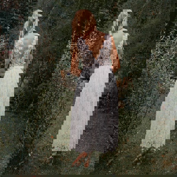 Flower girl in a Beautiful white lace dress