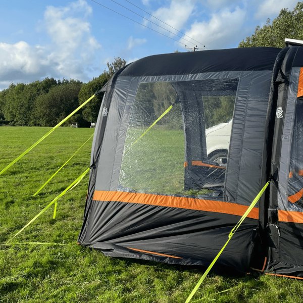 An image of the OLPRO Charcoal & Orange Cocoon Breeze Campervan Awning Extension attached to the Cocoon Breeze that has been fixed to a VW Campervan.