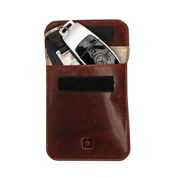 Brown leather key holder with a key fob on a white