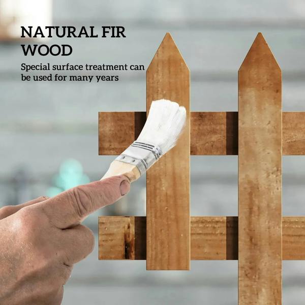 Brown wooden picket fence board and brush applying a protective wood surface finish