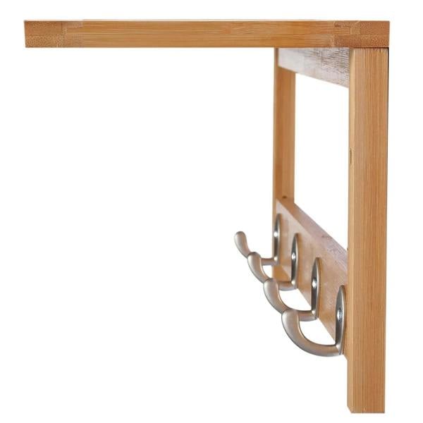 Close-up of triple metal hooks on a natural wood wall-mounted coat rack.