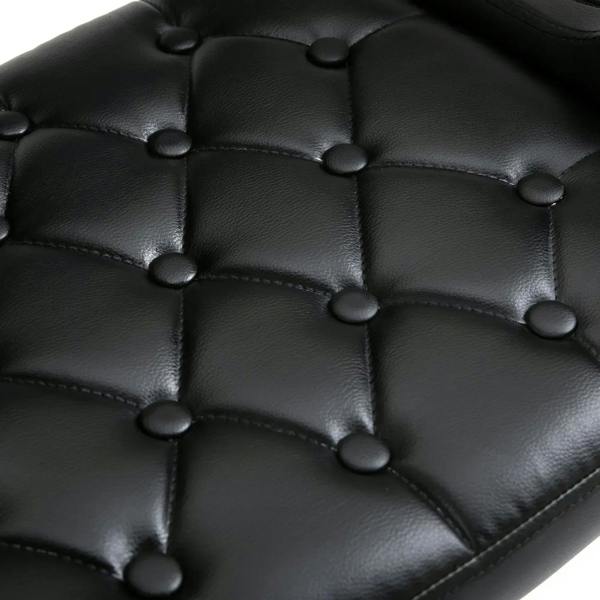 Close-up of black tufted PU leather upholstery on a swivel bar stool