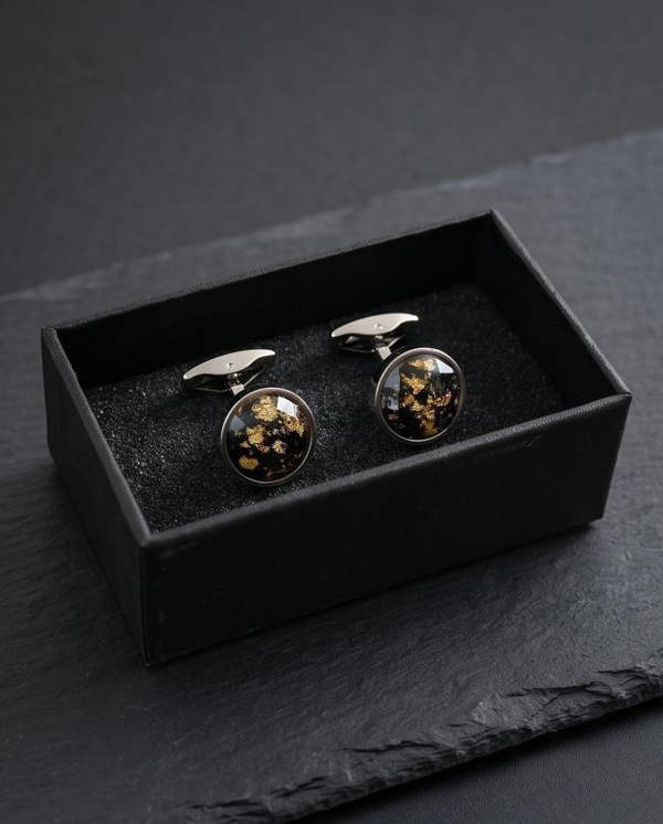 Cufflinks with floral design in a black box on a dark surface