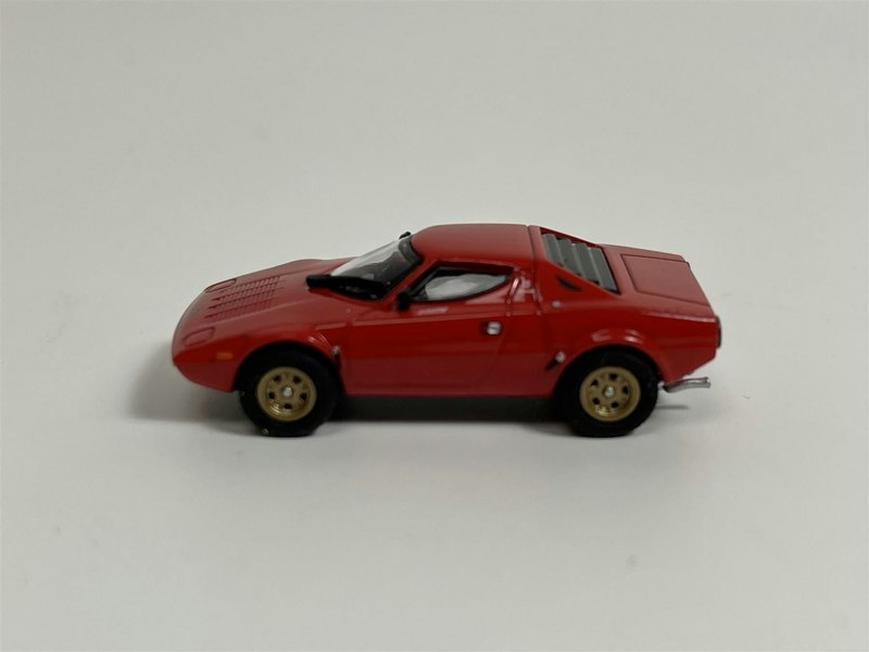 a red toy car on a white background