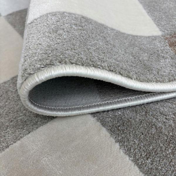 Gray geometric patterned rug with a textured border