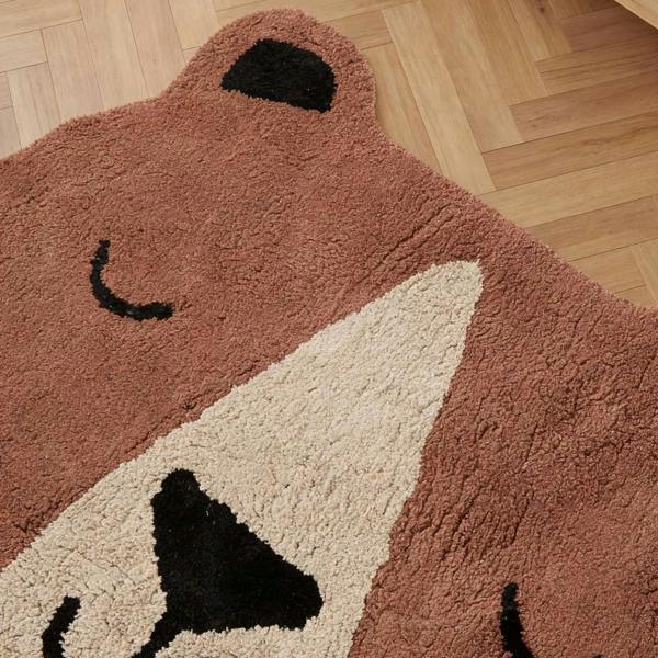Bear-shaped rug on a wooden floor