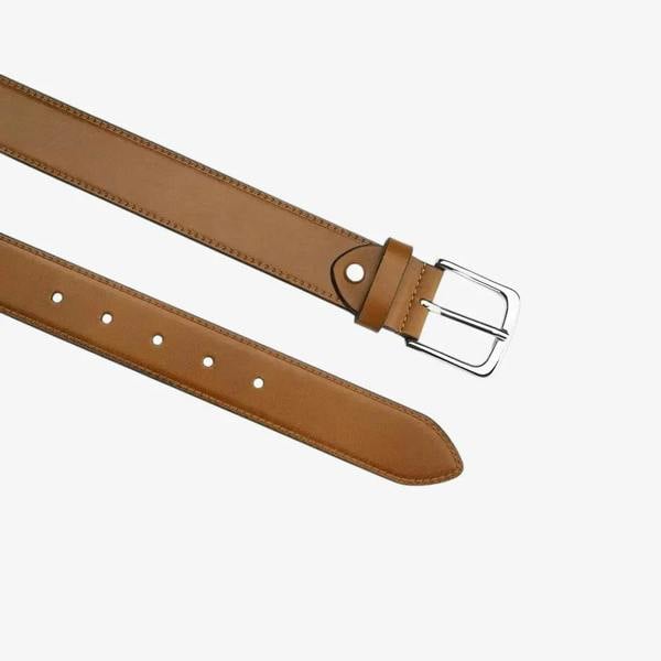 Top angle view of leather belt with silver buckle on a white background