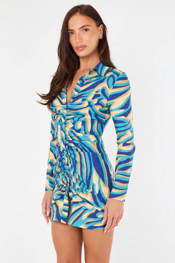 Woman wearing a colorful patterned dress on a white background