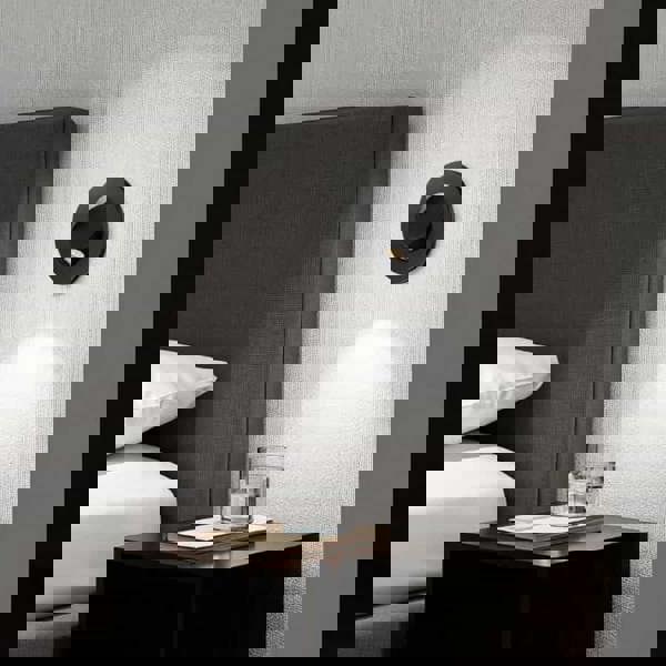 black recessed wall or headboard reading light mounted on the wall next to a bed over a bedside table