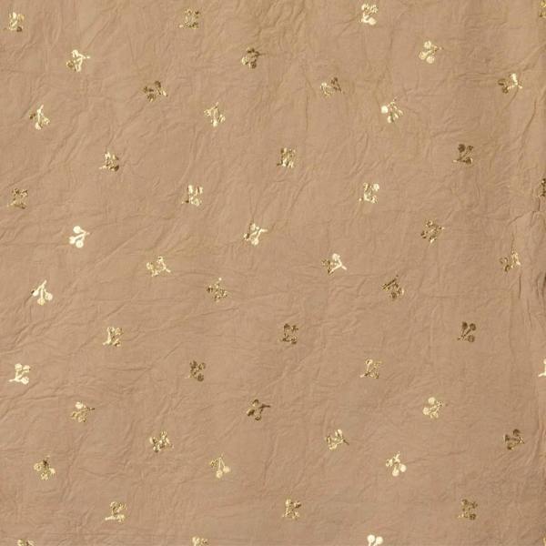 Close-up texture of warm truffle-coloured handmade recycled cotton wrapping paper featuring a gold foil berry pattern.