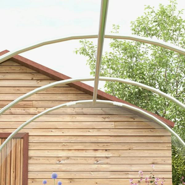 Walk-in greenhouse arched galvanised frame over wooden base with climbing plants