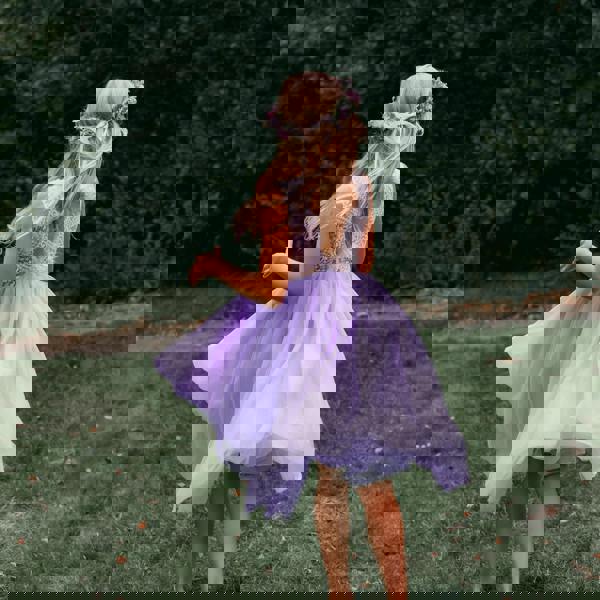 young girl wearing lilac flower girl dress