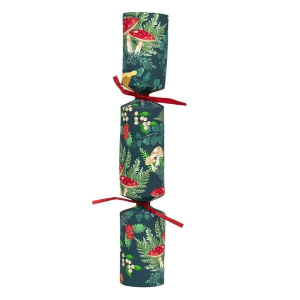 A single handcrafted Christmas cracker featuring a dark green background with red toadstools and holly berries.