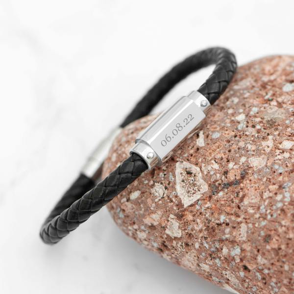 Personalised men's black braided leather bracelet wrapped around a terracotta stone with a stainless steel plate engraved with 06.08.22