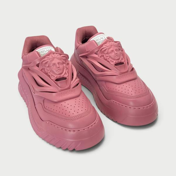 Supplied Fashion Versace Odissea sneakers in jam red featuring a prominent Medusa head motif and chunky rubber soles.