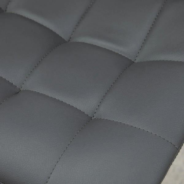 Close-up of grey tufted PU leather bar stool seat with stitched square pattern