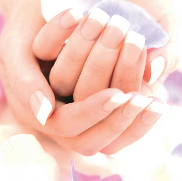 ladies hands with perfect french tip acrylic manicure 