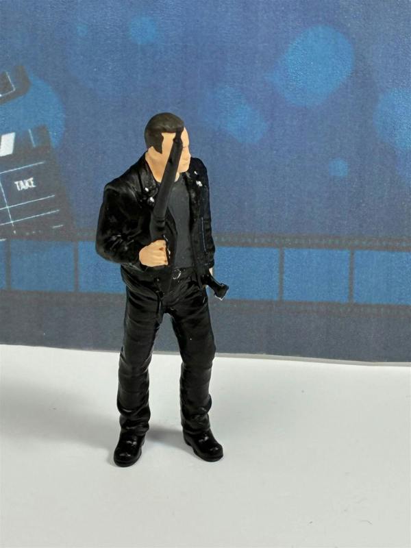 a toy figurine of a man holding a gun