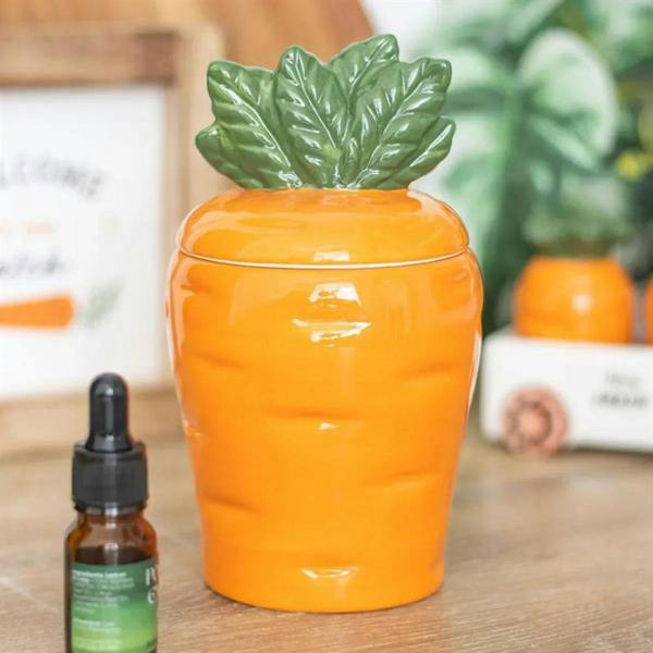Carrot-shaped oil burner with orange ceramic body and green leaf lid